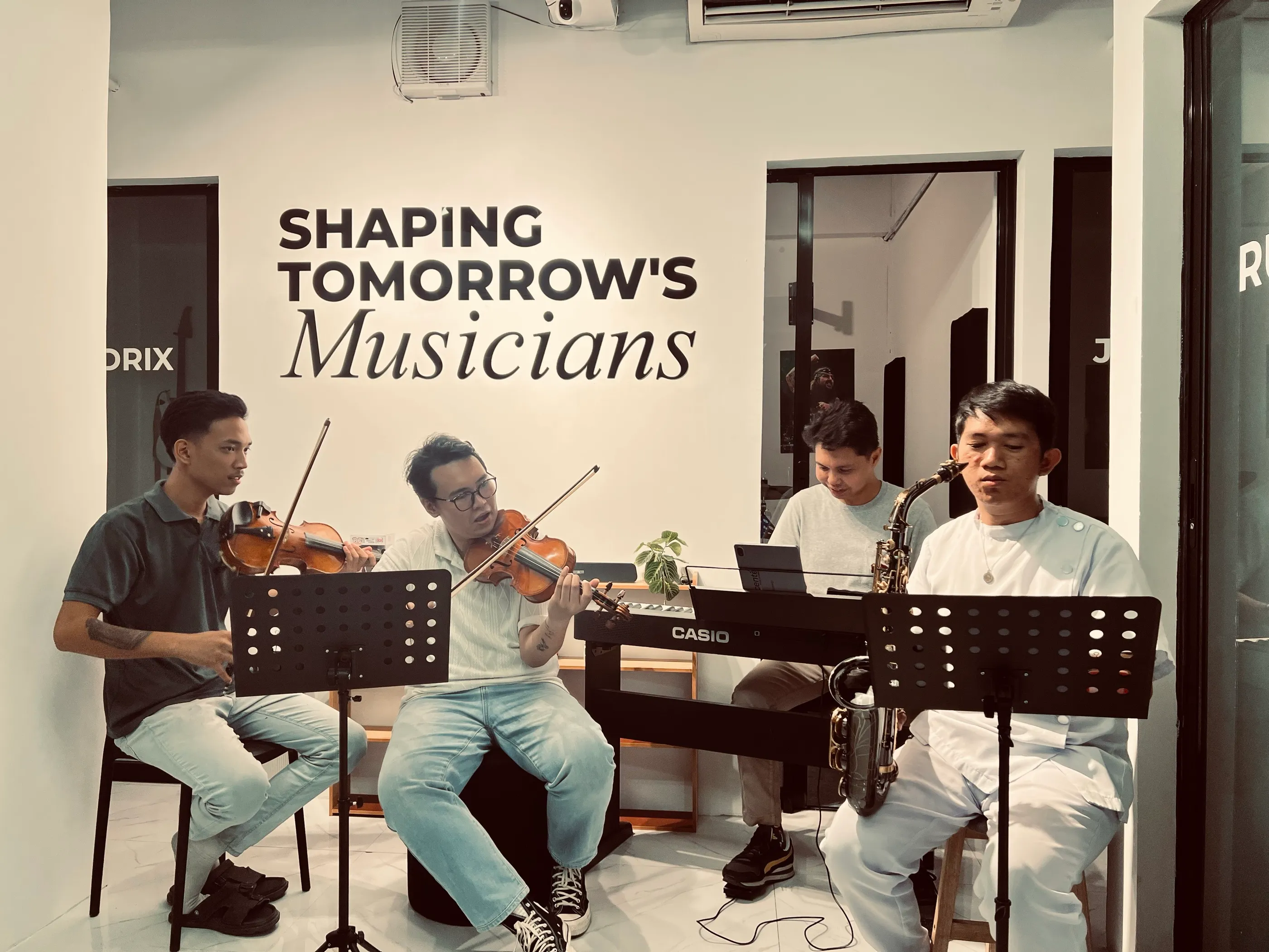 Violin, keyboard, and saxophone students rehearsing at Ascente Music Academy in Batangas City