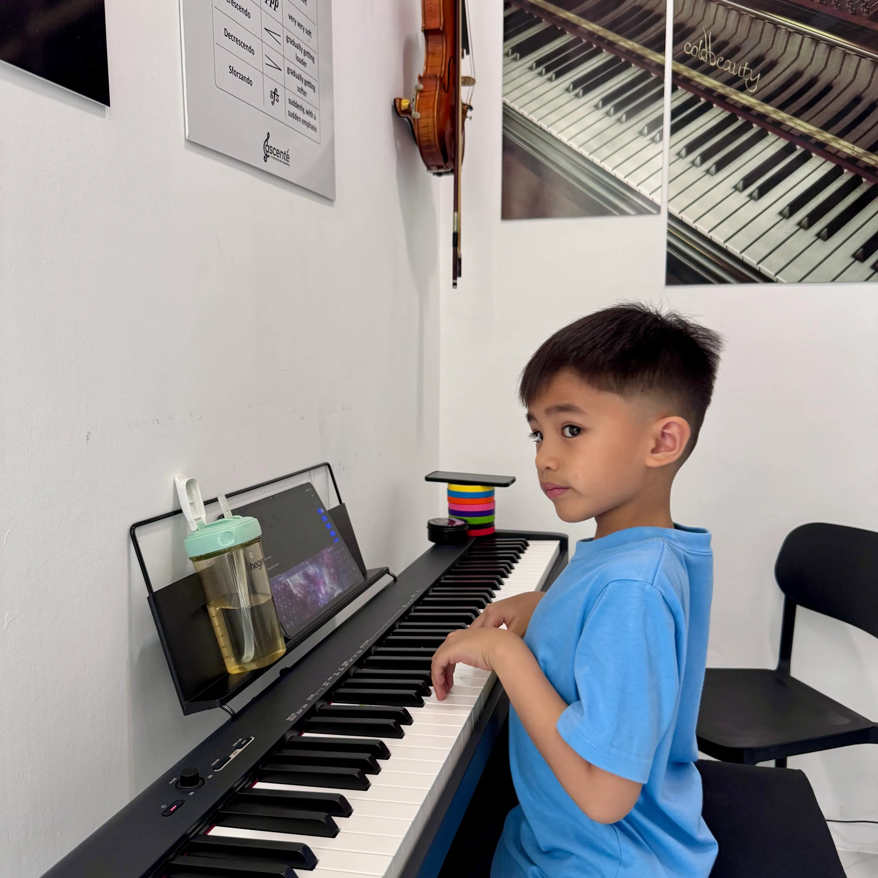 A young student at the piano during a lesson at Ascente Music Academy