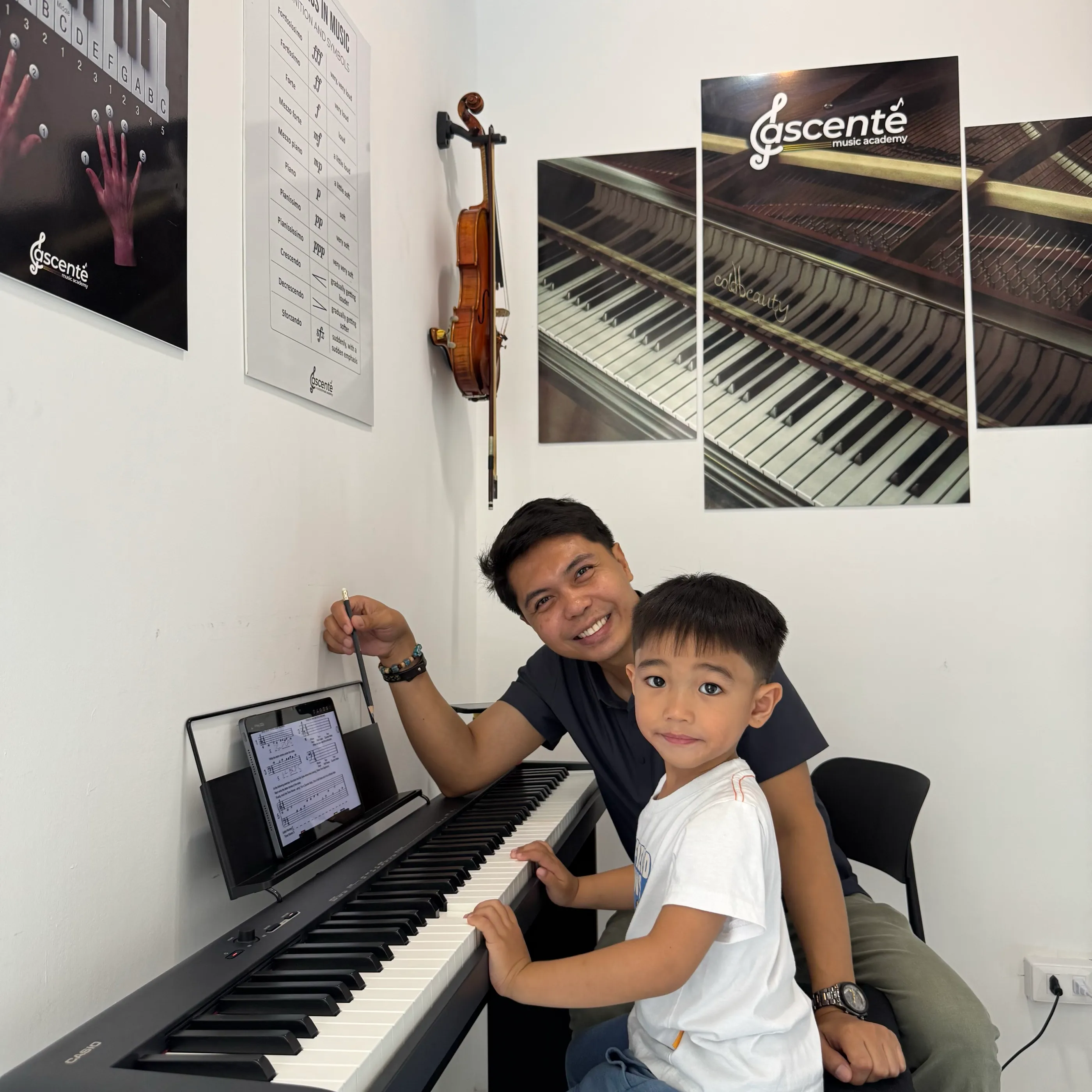 A teacher and a young piano student during a lesson at Ascente Music Academy
