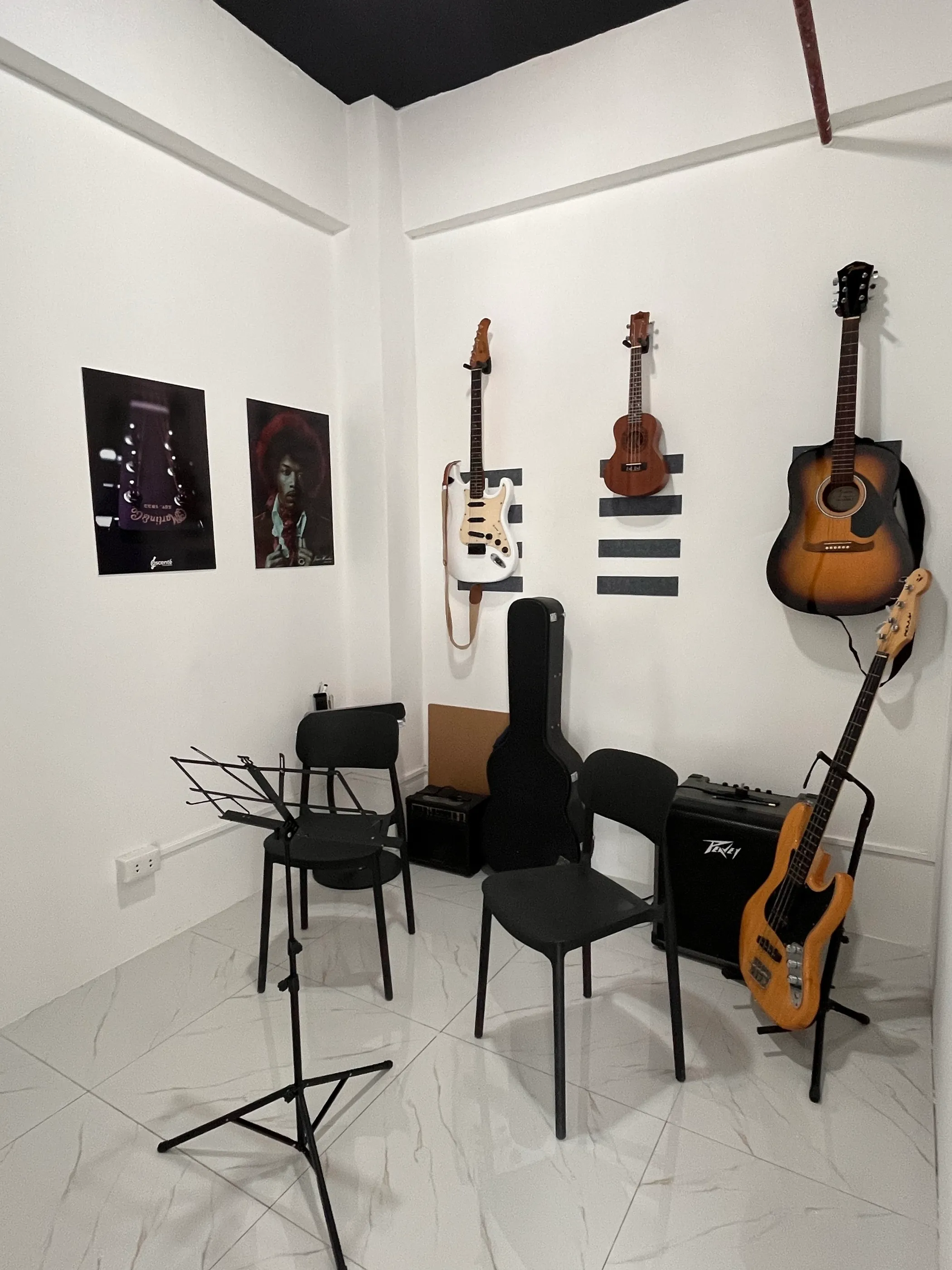 Guitars and a bass hanging in the guitar studio