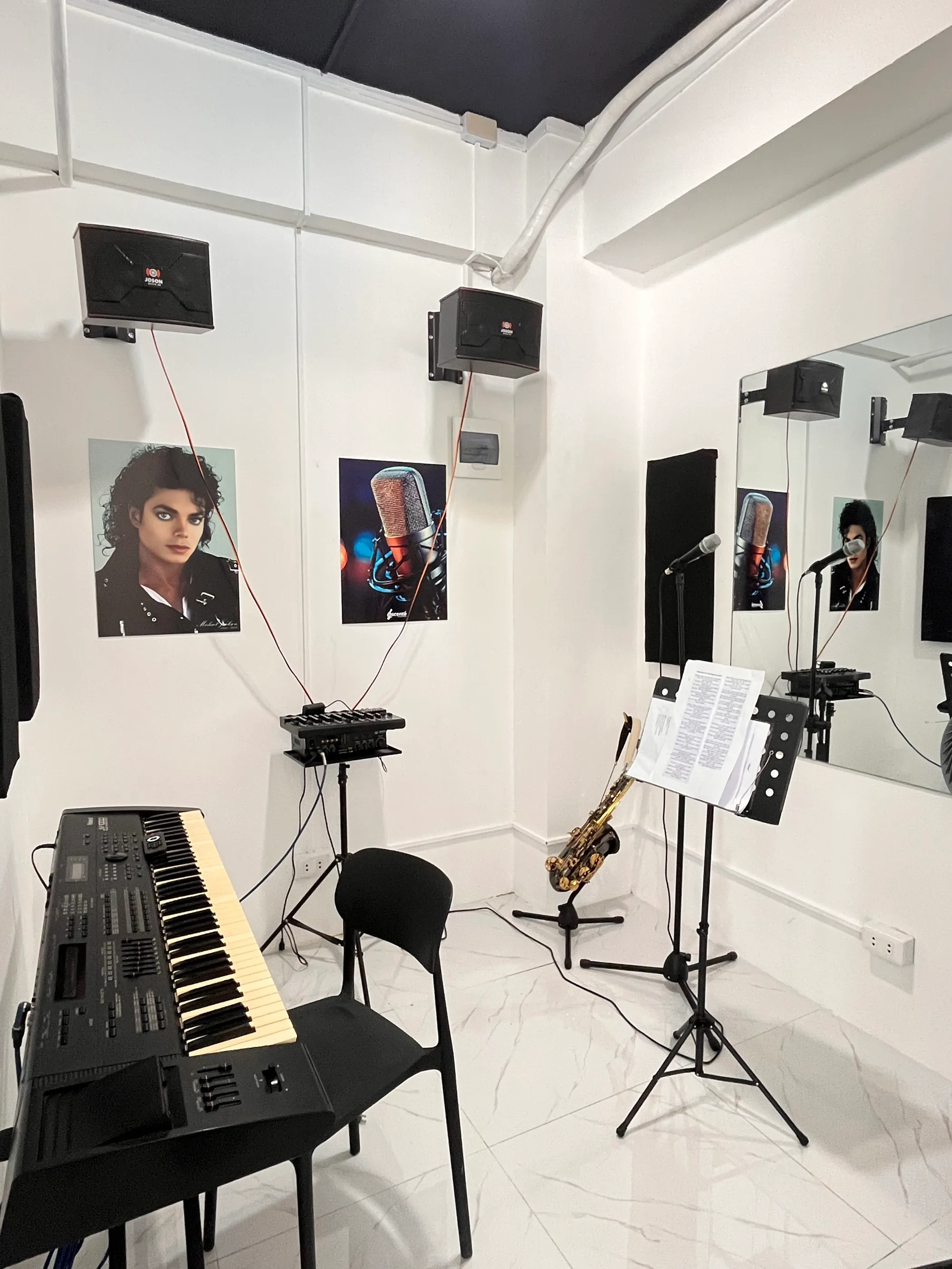 The voice studio, with a keyboard, microphone, and music stand